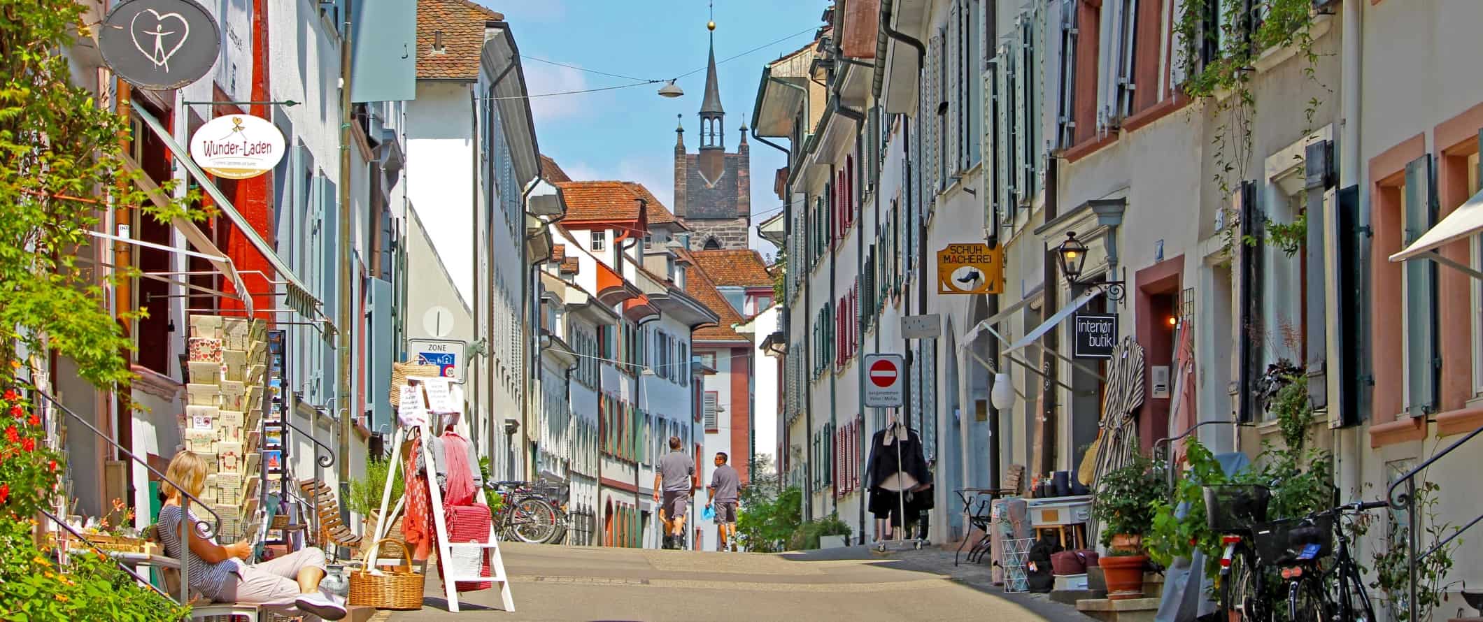 Rua com edifícios brancos com persianas pintadas de cores vivas no centro histórico de Basileia, Suíça
