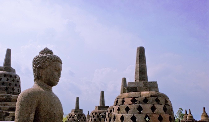 A estátua desgastada do Buda em Borobudur na Indonésia