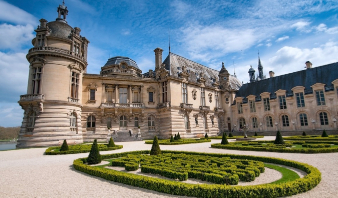 O castelo histórico de Chantilly na França cercado por belos jardins