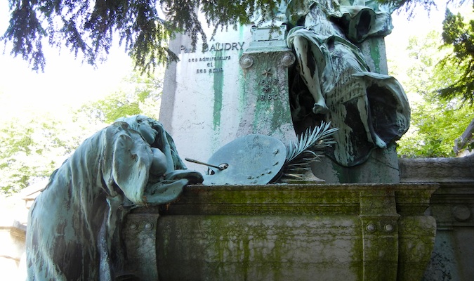 Estátuas de luto resistidas no cemitério Pere Lachaise em Paris, França