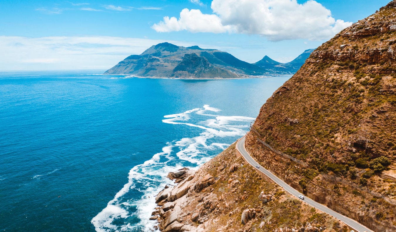 Carro em uma estrada costeira sinuosa na África do Sul