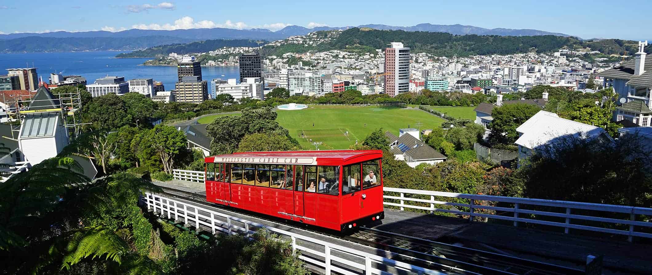O teleférico Wellington Red sobe a encosta com a cidade de Wellington, na Nova Zelândia, ao fundo.